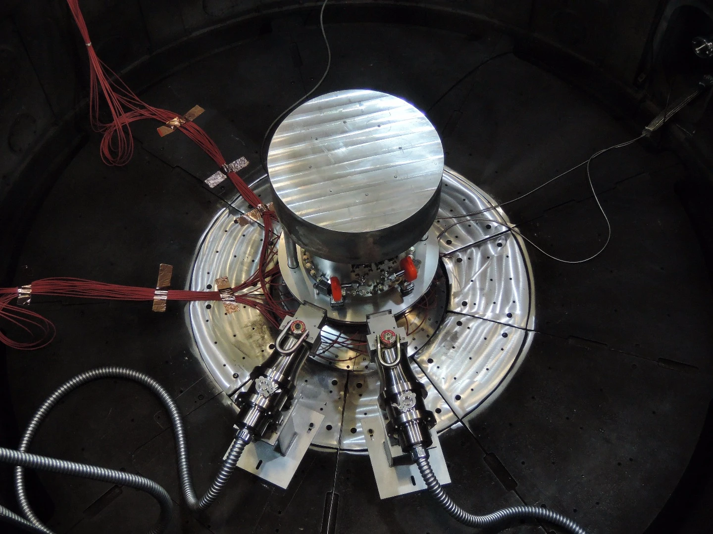 Two fast neutron radiation-effects cassettes aim toward the center of the containment system for tritium within the Z vacuum chamber at Sandia National Laboratories