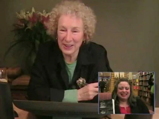 Atwood and the book recipient can see each other and themselves depending on how the LongPen is configured. Image by Unotchit.