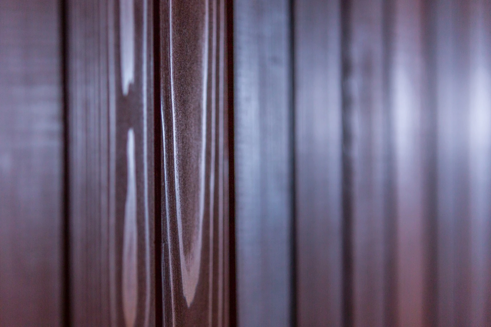 The tiny home is clad in clear cedar siding and trim, with steel accent and protective panels