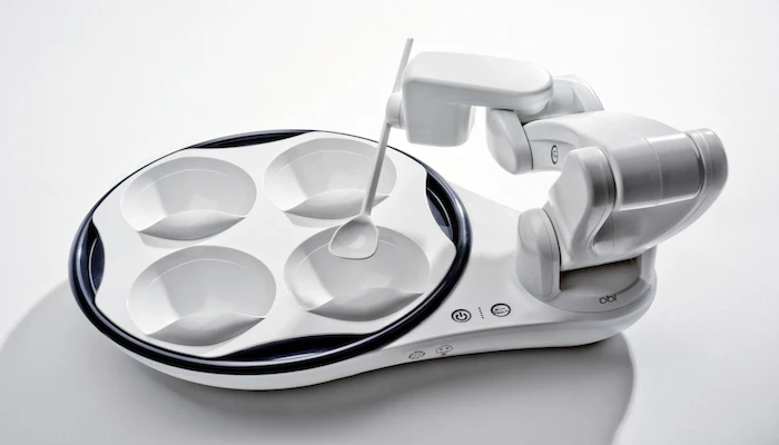 Obi's plate contains four separate bowls, which allows users to decide which food they want in each individual spoonful