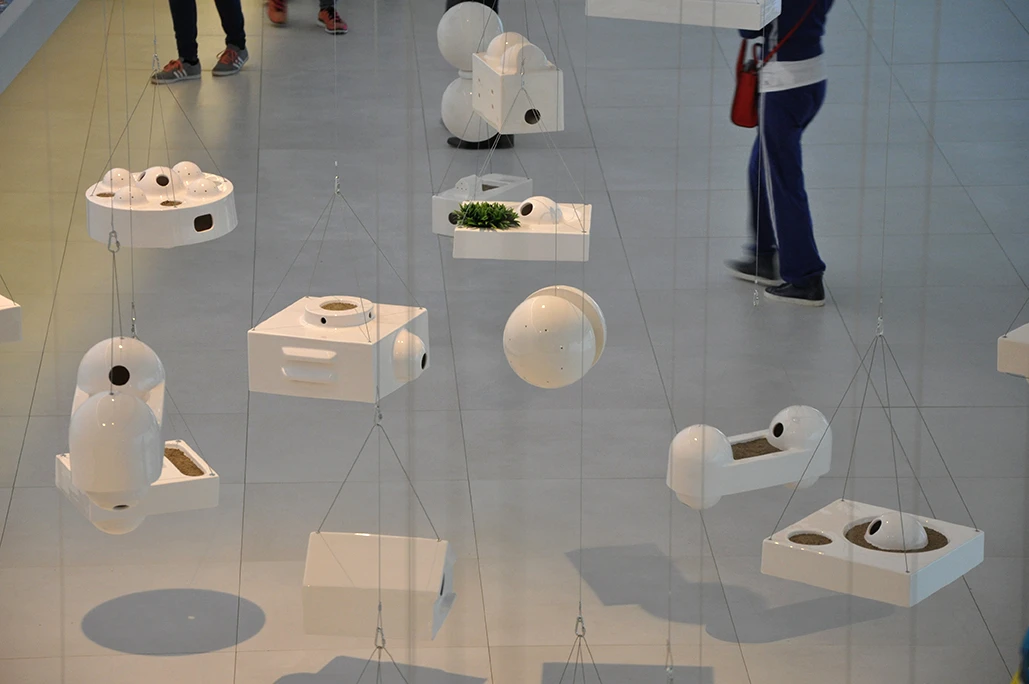 Brazil's interior gallery space is filled with hanging plants, resembling hundreds of different birdhouses