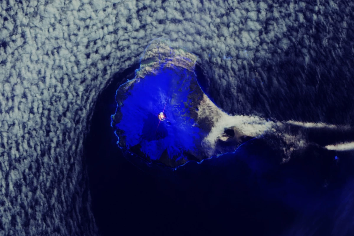 In this image captured by the Copernicus Sentinel-2 mission, a distinct hotspot can be seen in orange in the crater of the volcano