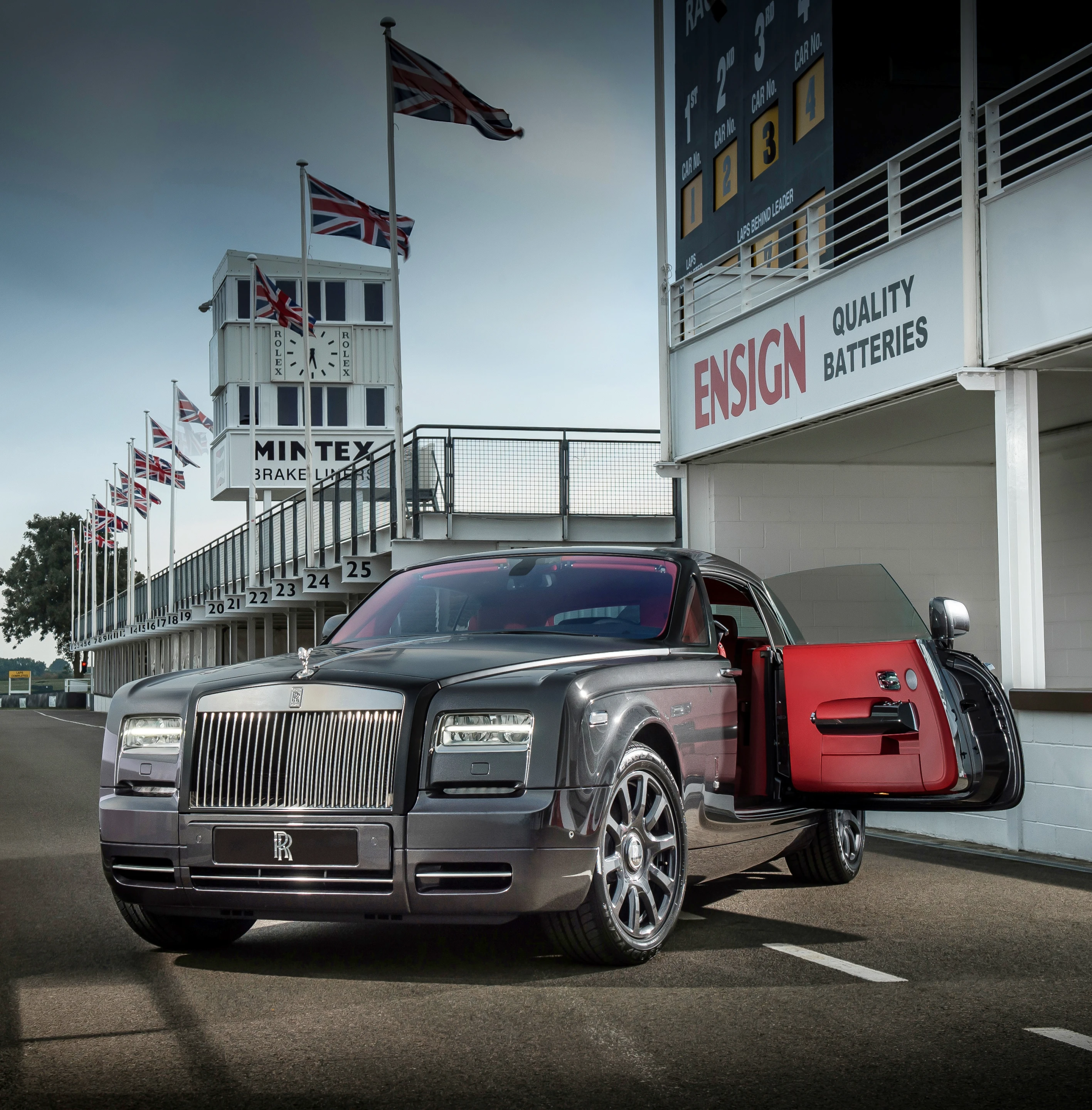 The exterior features gunmetal paint with black around the hood and windshield frame