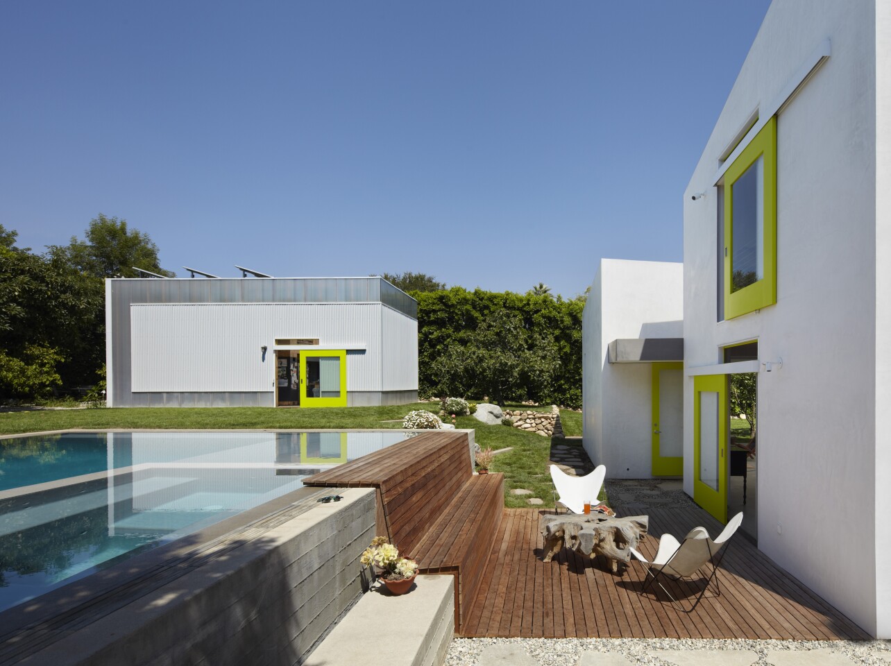 The Informal House features green lower roofs which help insulate the interior, while the higher roof is colored white and in a bid to minimize solar heat gain (Photo: Eric Staudenmaier)