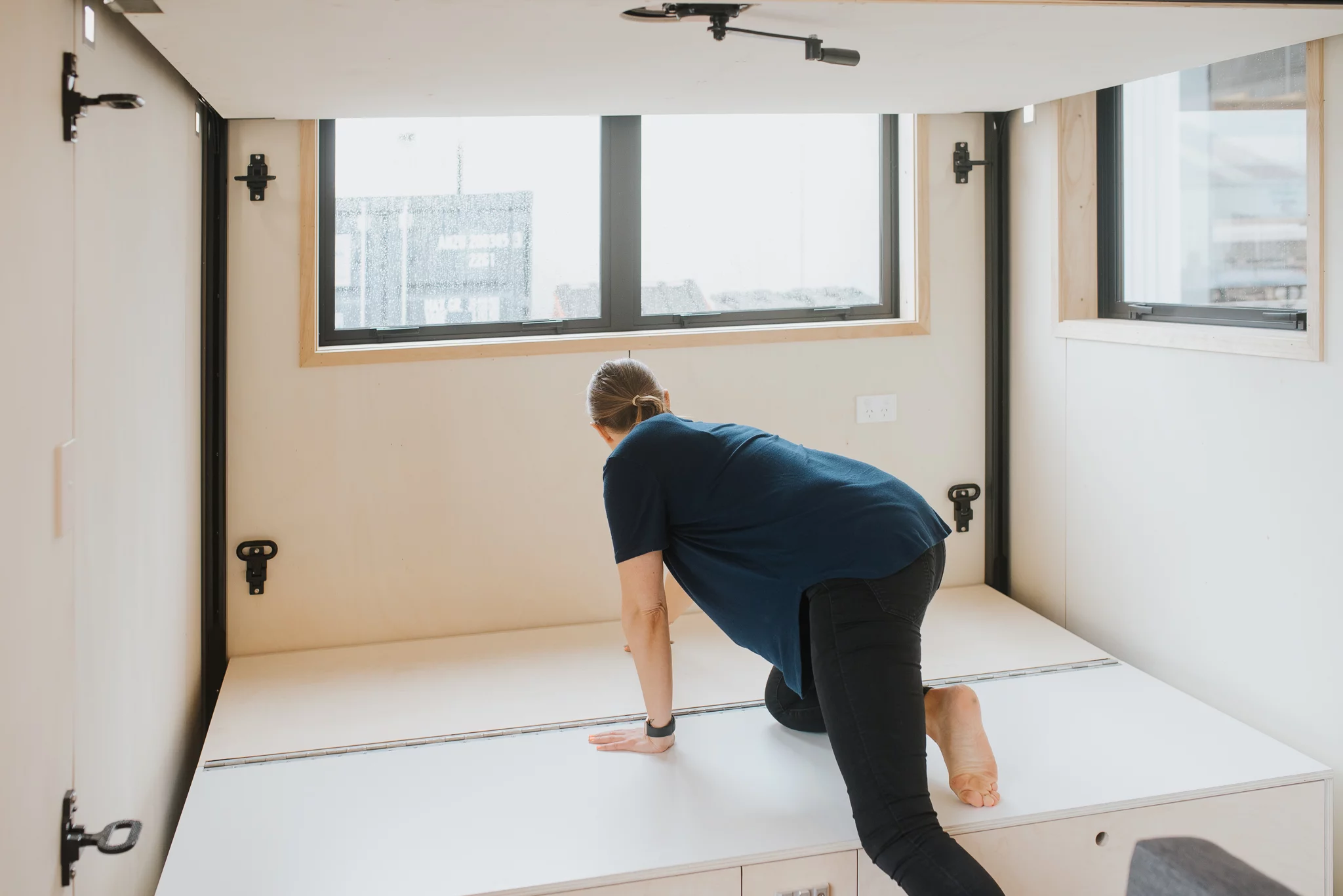 The Te Whare Nukunuku Tiny House's storage-integrated sofa can transform into a secondary bed