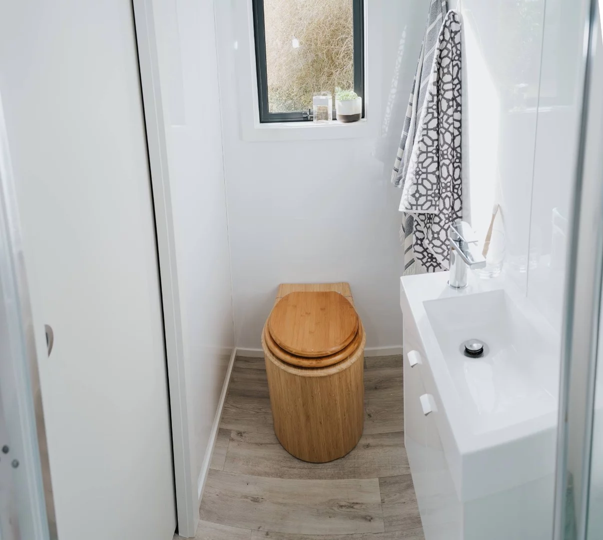 The Camper Tiny House's bathroom includes a composting toilet