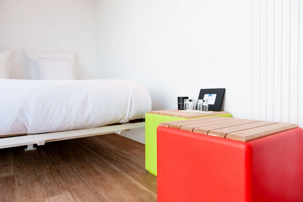 Each 20-foot long guest room has enough space for a floating box-spring bed, iPod docking station, air conditioning, and a bathroom area with a toilet and rain shower