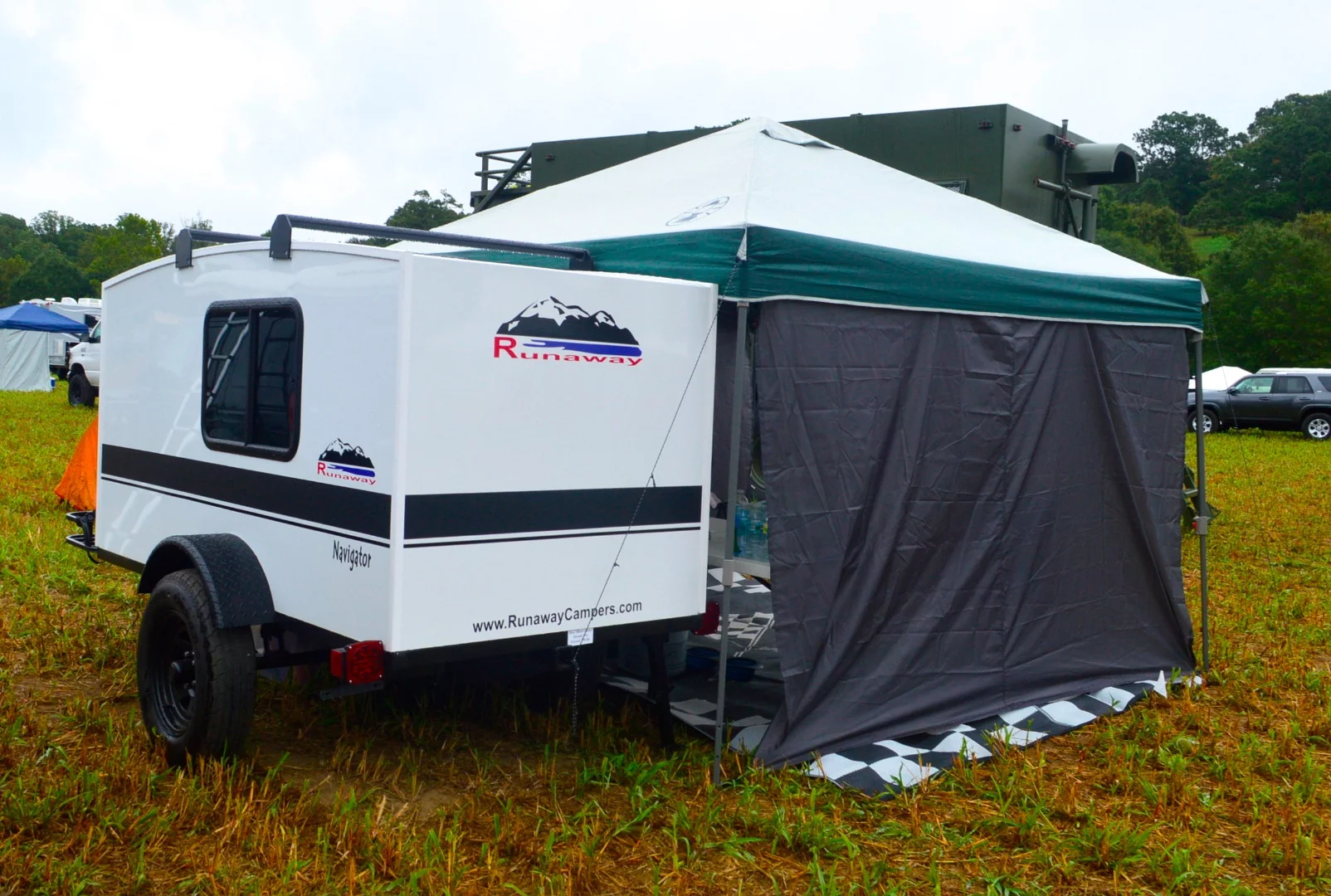 We spotted this Runaway Campers trailer out in the parking lot, unattended, but a little Web research reveals Runaway is another company specializing in basic, affordable camping trailers similar to the Wee Roll MPV. The $2,495 "BaseCamp" model is an empty shell with door and tinted windows, and other models add some basic equipment and price. Pictured here is the $3,495 Navigator model, which includes an air conditioner, LED taillights, front cargo rack, bottom mounted spare tire and a few other upgraded components