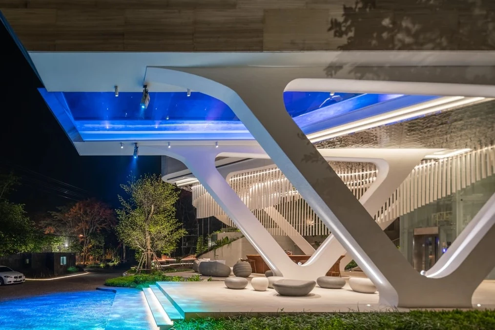 At night, the pool bathes the reception area in watery blue light