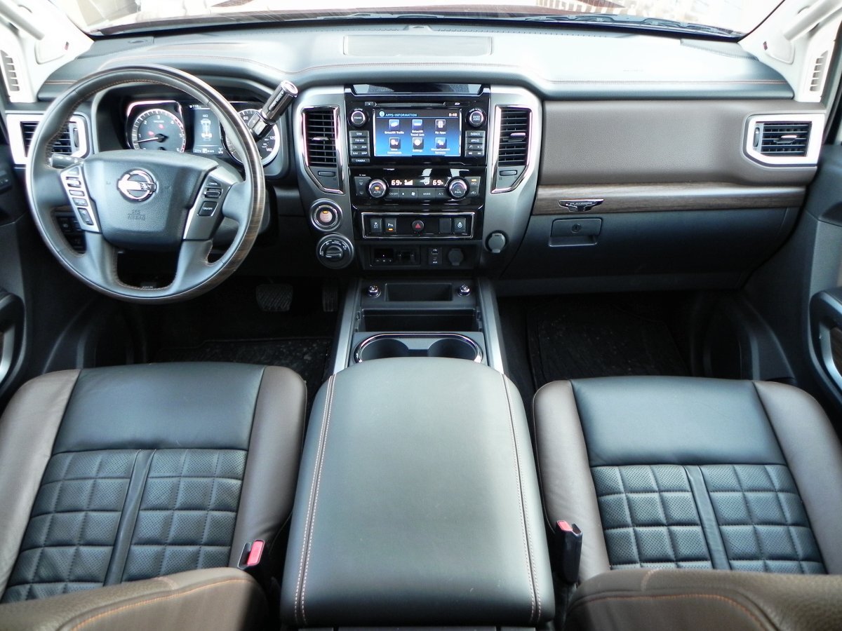In five-person seating arrangements (front buckets), the space between the seats is dominated by a huge, deep storage compartment that is larger than most studio apartments in Hong Kong