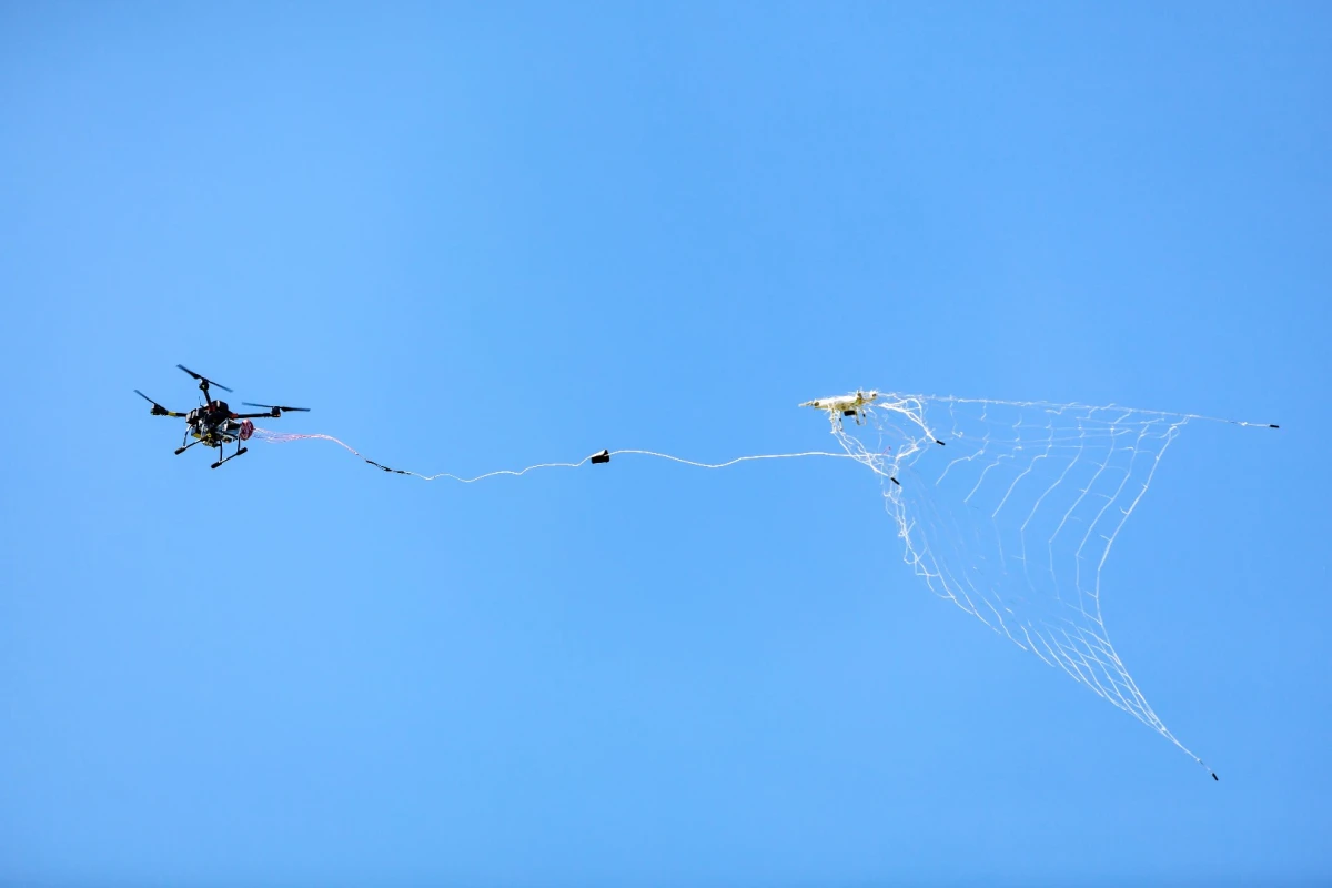 The DroneCatcher uses its pneumatic net gun to shoot a net at an intruding drone from a distance of up to 20 m (66 ft), capturing it