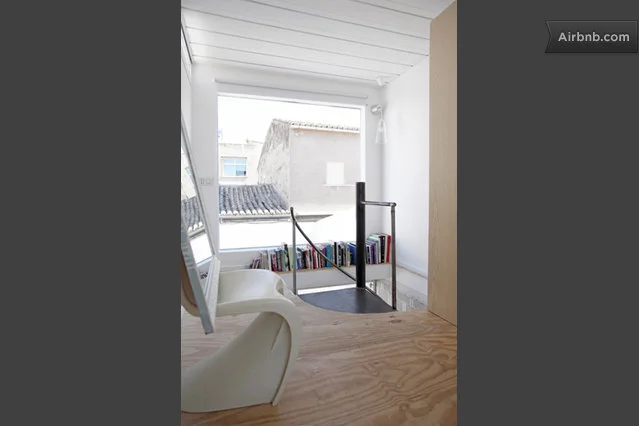 The home features designer furnishings, wooden floorboards, floor-to-ceiling windows and space saving spiral staircases