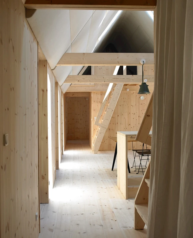 Modern Seaweed House features raw wooden interior furnishings