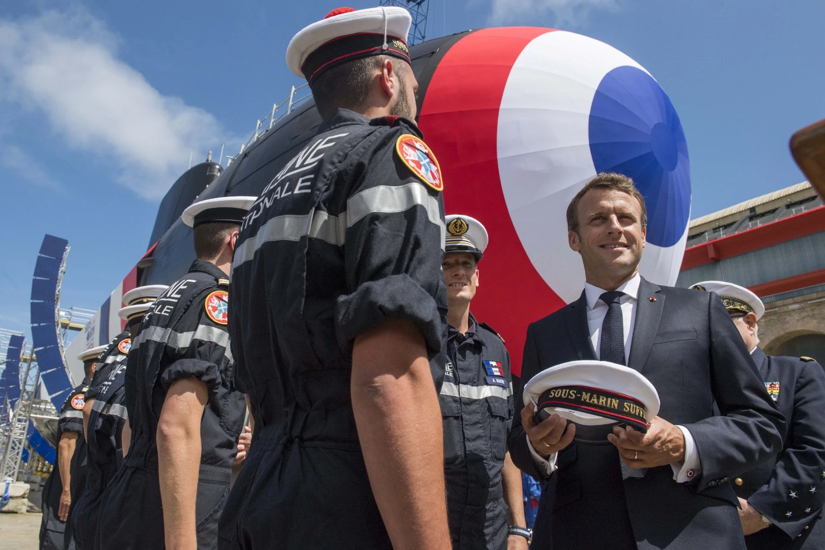 Macron receiving a service cap