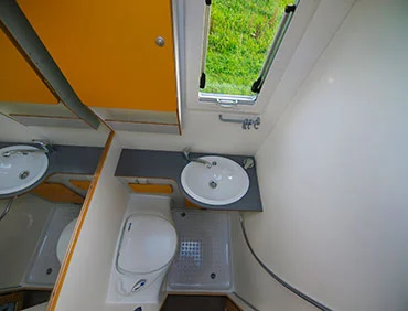 The bathroom includes a shower, sink and toilet