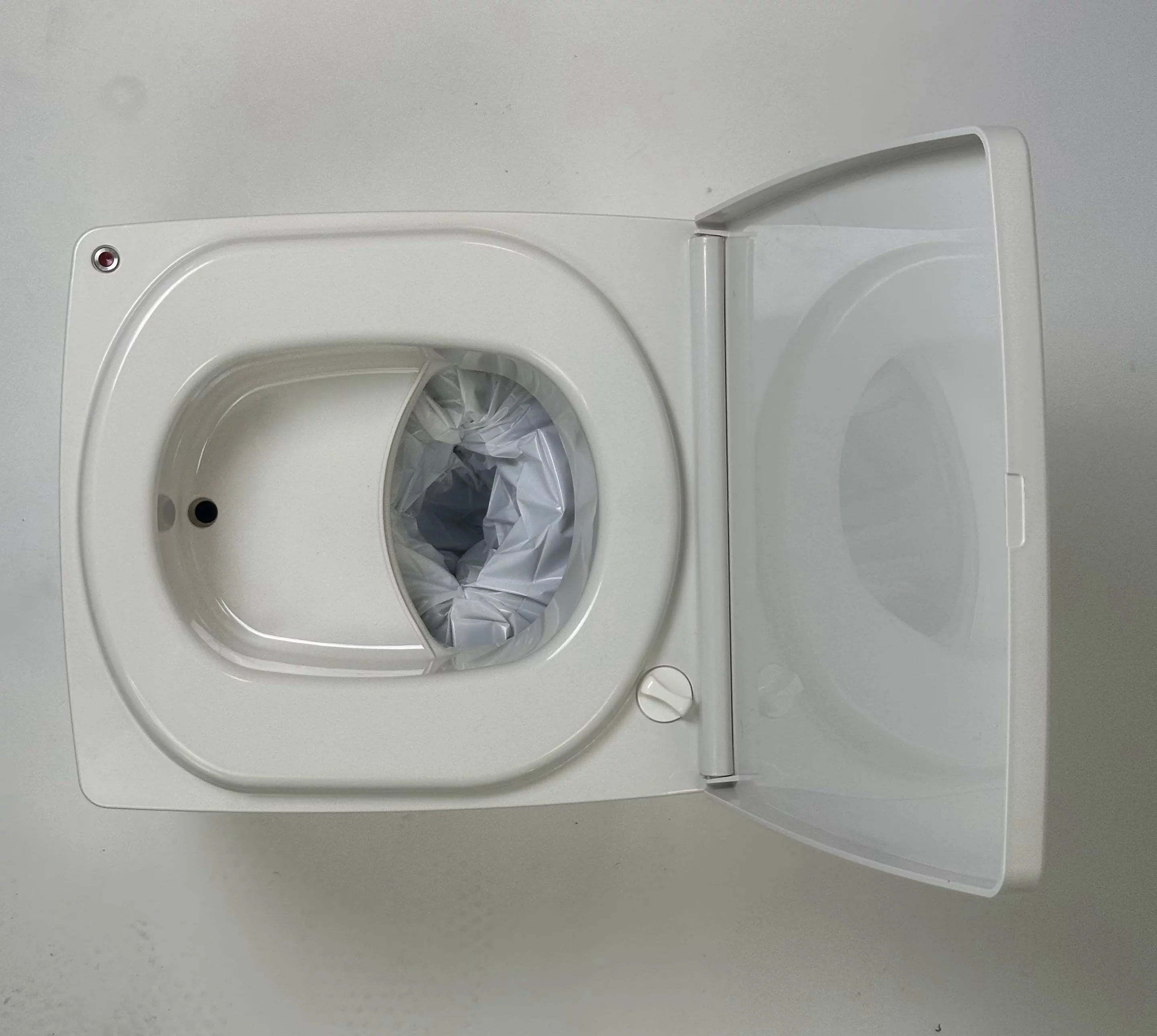 The panels retract to drop waste into the baggy