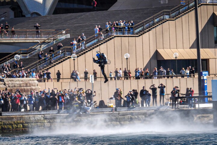 Ferocious jets whip up the water below David Mayman as crowds line the stairs of the Sydney Opera House