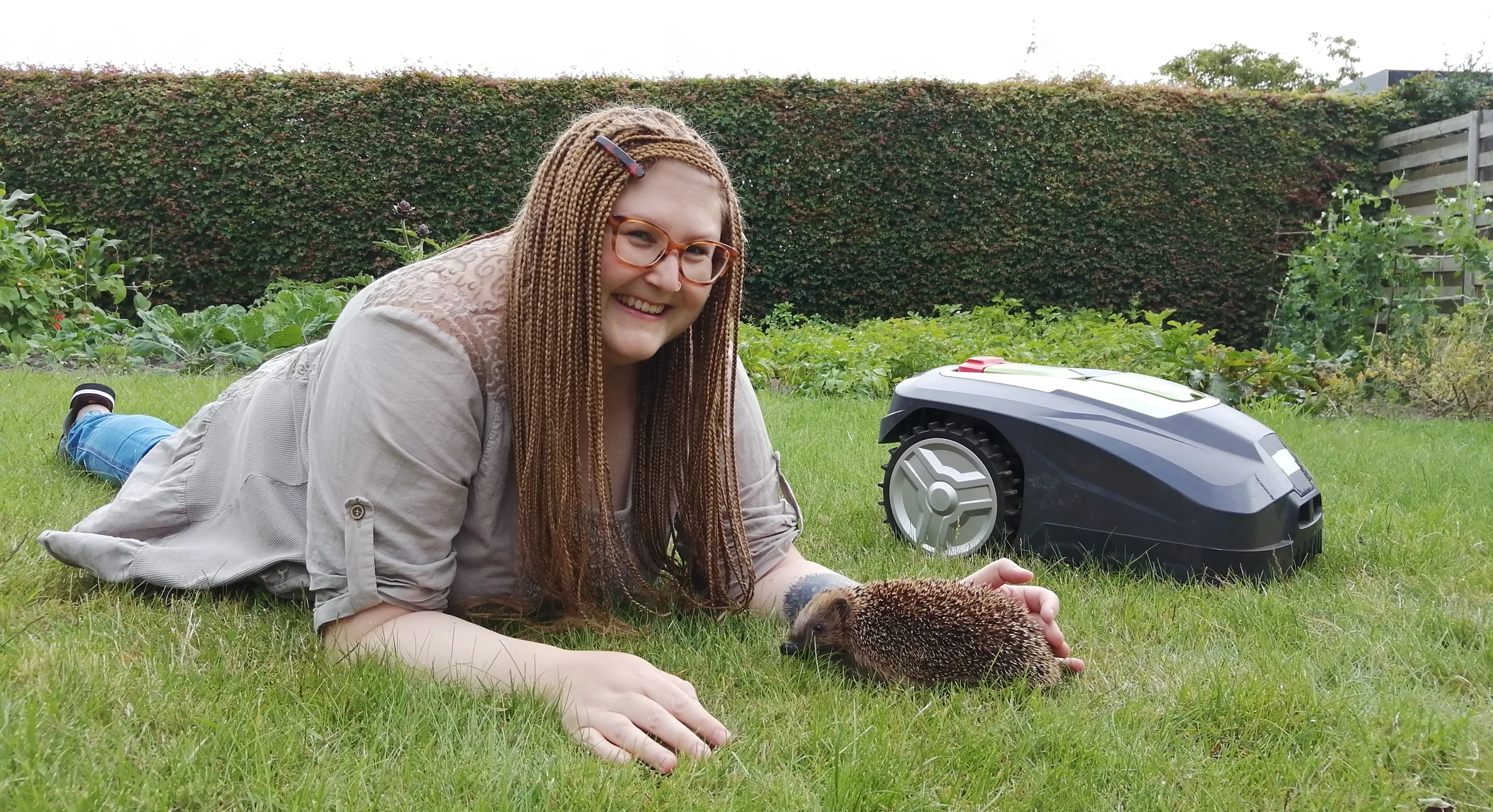 Dr. Sophie Lund Rasmussen (aka "Dr. Hedgehog") with a hedgehog and a mower