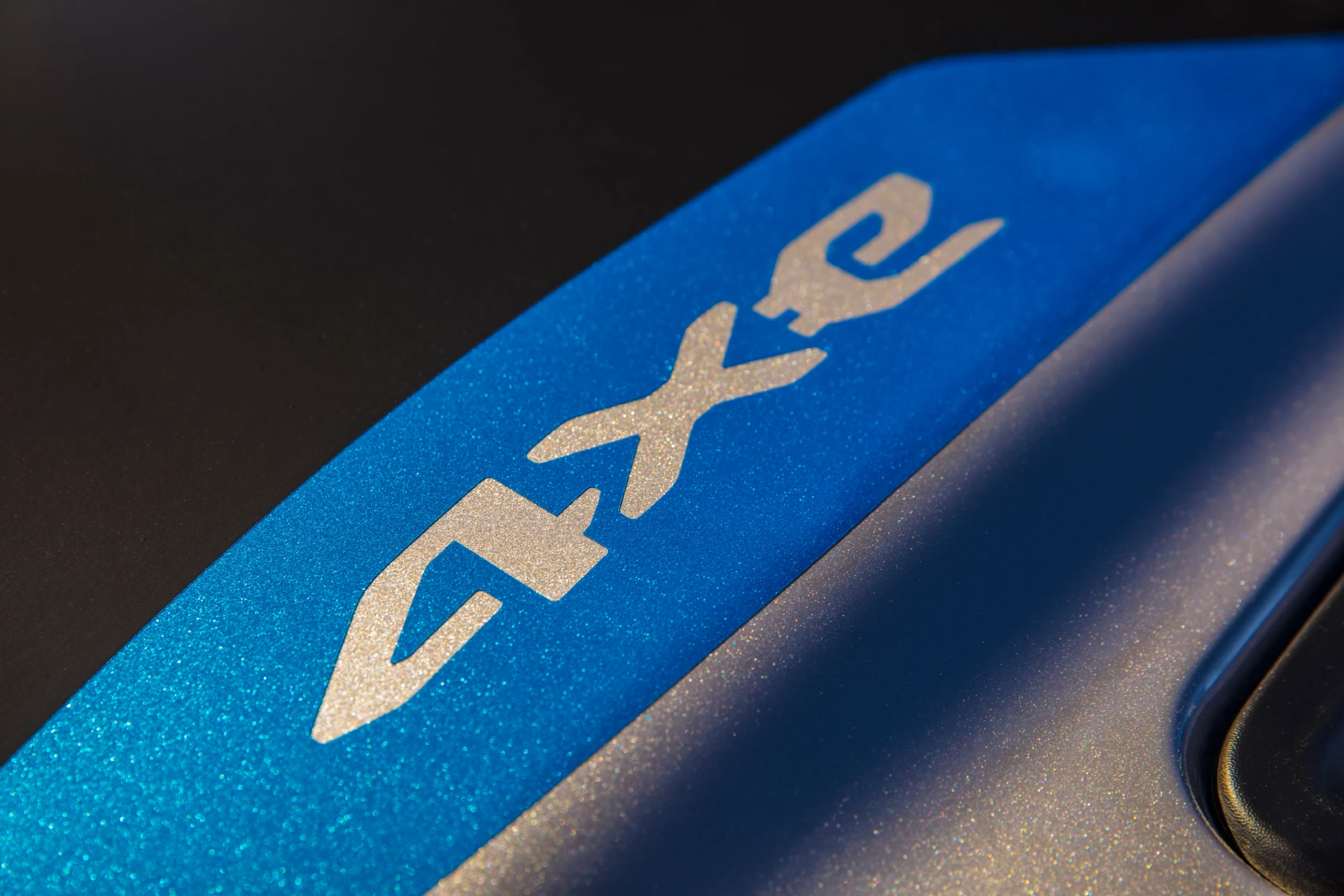 The 4xe logo on the hood of the 2021 Jeep Wrangler lets the body color show through