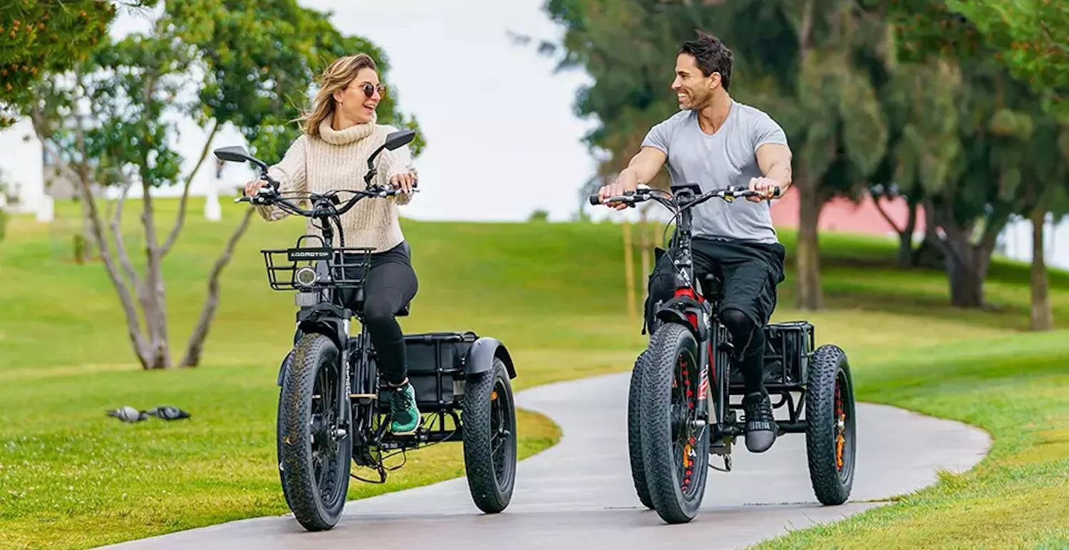 The 2023 M-340 (left) features a step-through aluminum alloy frame with a wooden platform for resting your feet when using the twist throttle