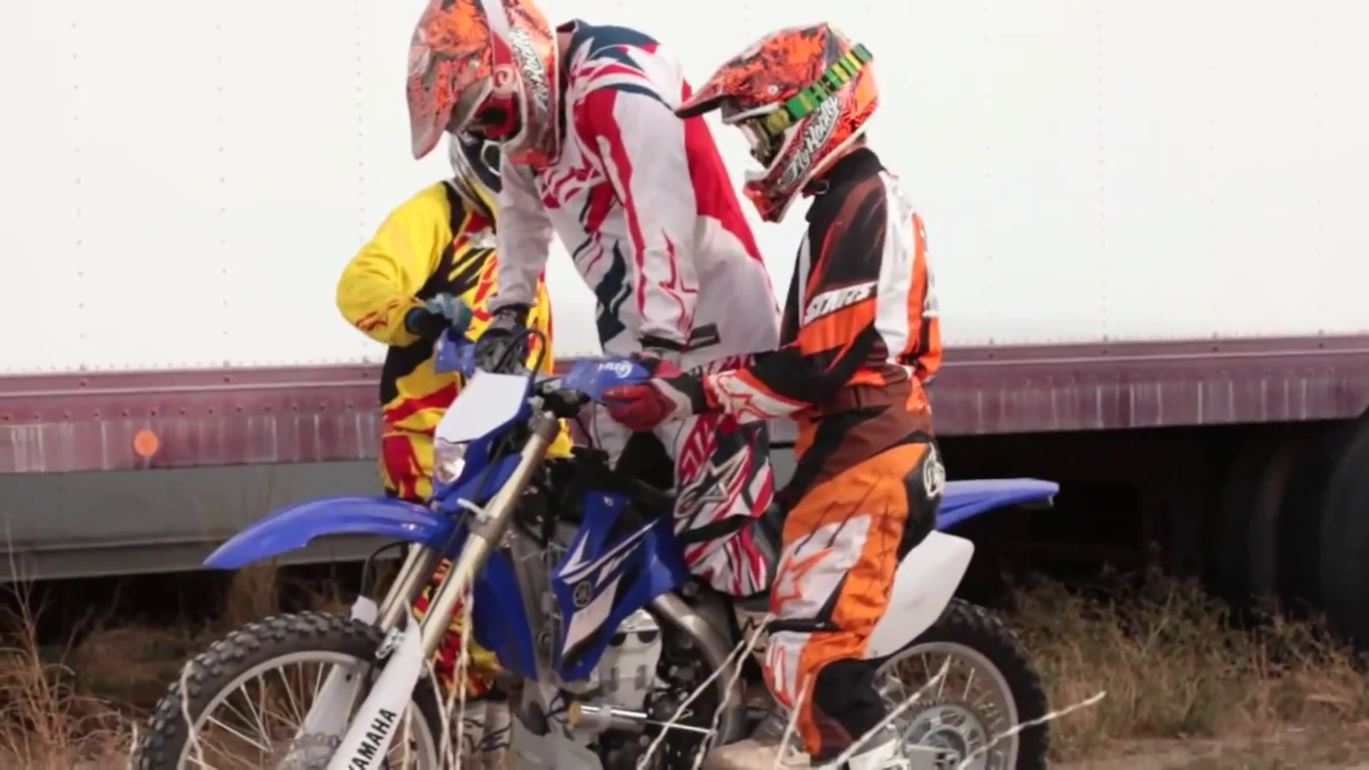 Friends or family helping Tanner back onto his motorcycle