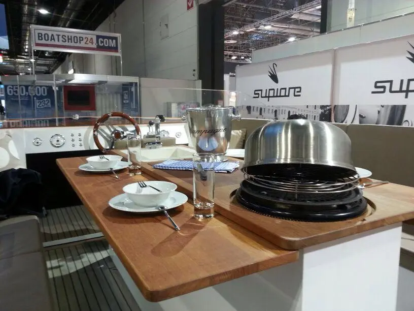 The central table unit has a BBQ, drink cooler and sink