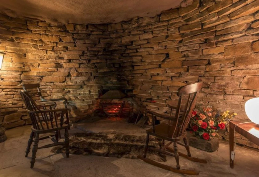 This area, dubbed The Cave, features a peat fireplace