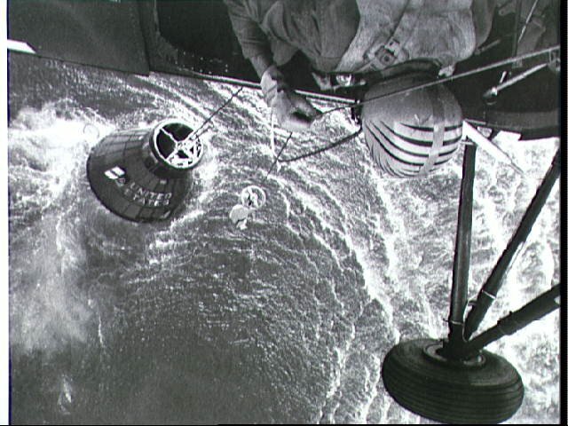 Recovery helicopter lowering the sling to rescue Grissom