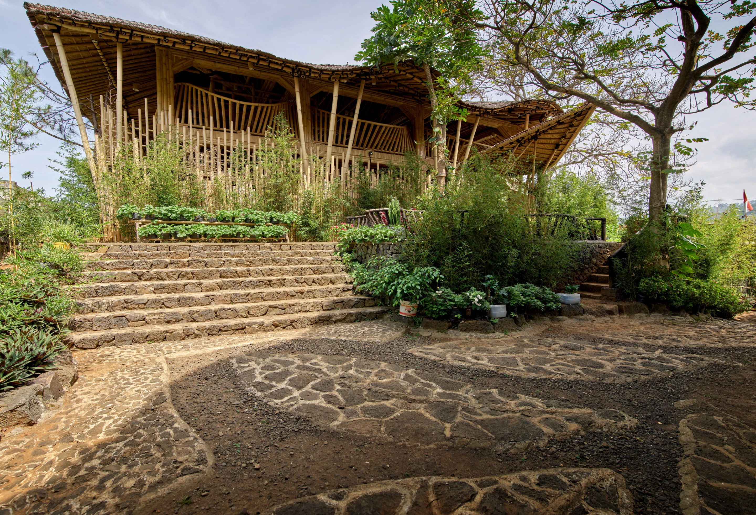 Exterior view of Kujang, which consists of a bamboo and stone structure