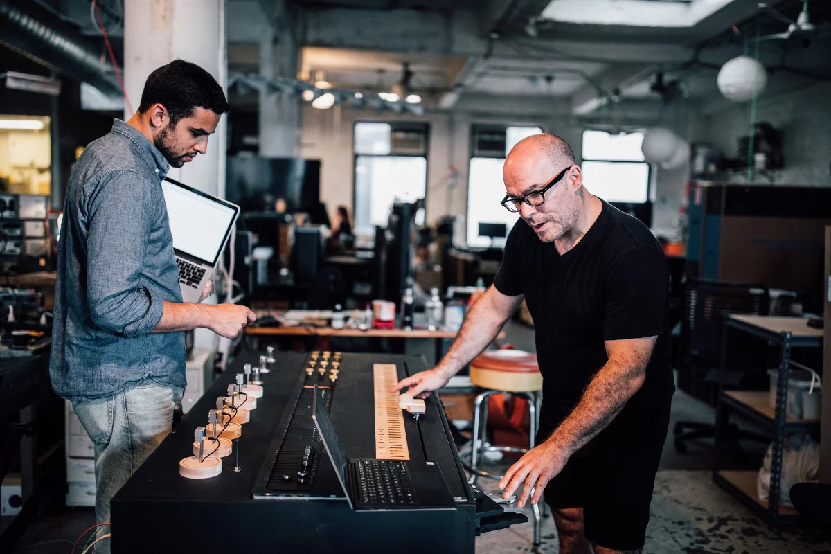 Dual Coincidence creator Andy Cavatorta (right), seen here working on a different project