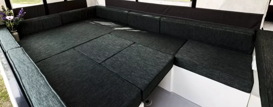 The dining table drops down to support the cushions that fill out the main bed