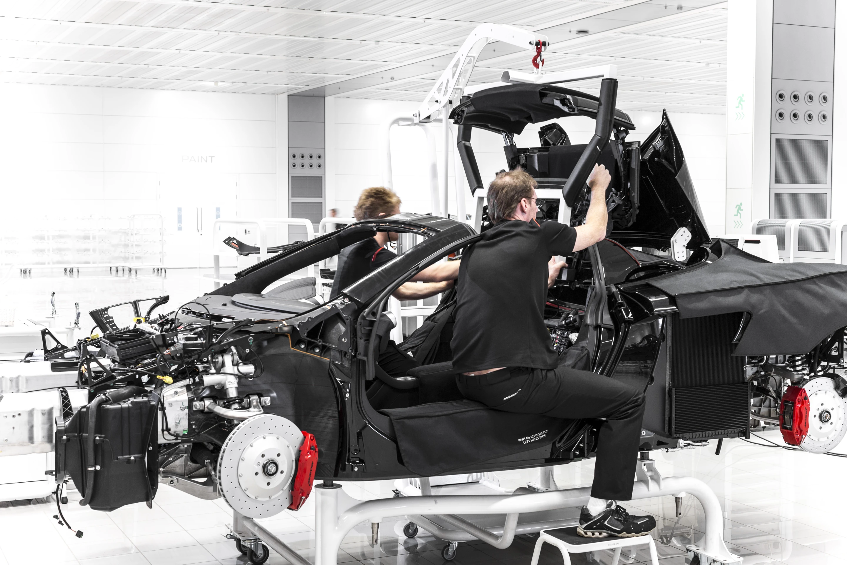 12C production shows forward steering, suspension and brake components attached to the passenger monocoque
