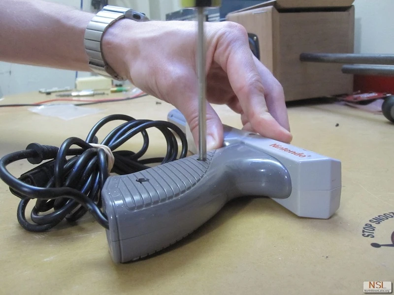 The basic components used to make the NES Zapper Laser included batteries, a 445 nm diode, lens, key switch and heat-sink