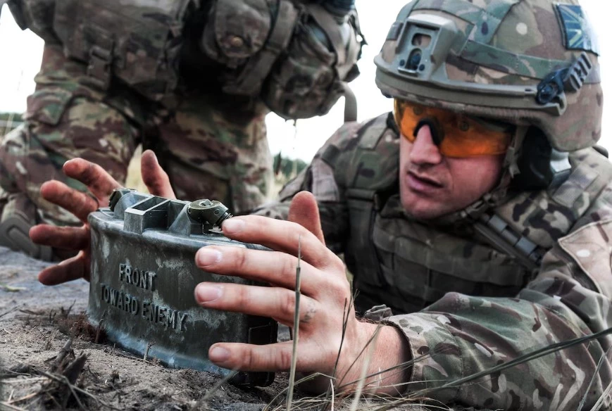 British Army Sergeant setting up Claymore mine during NATO exercise in Poland