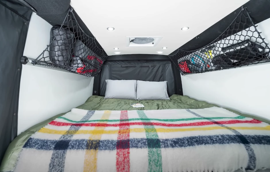 The large longitudinal bed offers a number of advantages: plenty of sleeping space, the ability to get up without rolling over the other person and no need for the sidewall flares necessary to fit a transverse bed