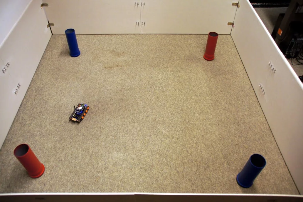 The robot was placed in an enclosure, in which both red and blue cylinders were present