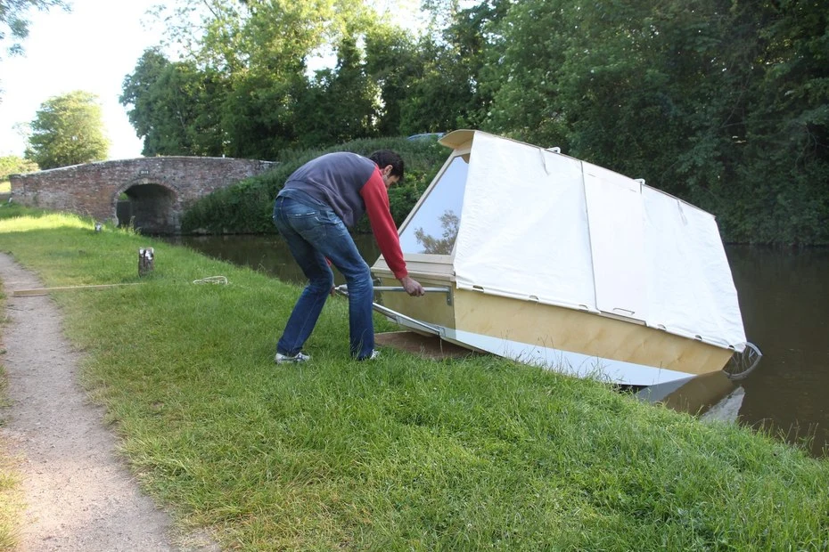 The prototype floating home is built primarily from wood and can be towed with a bicycle using a clip-on attachment