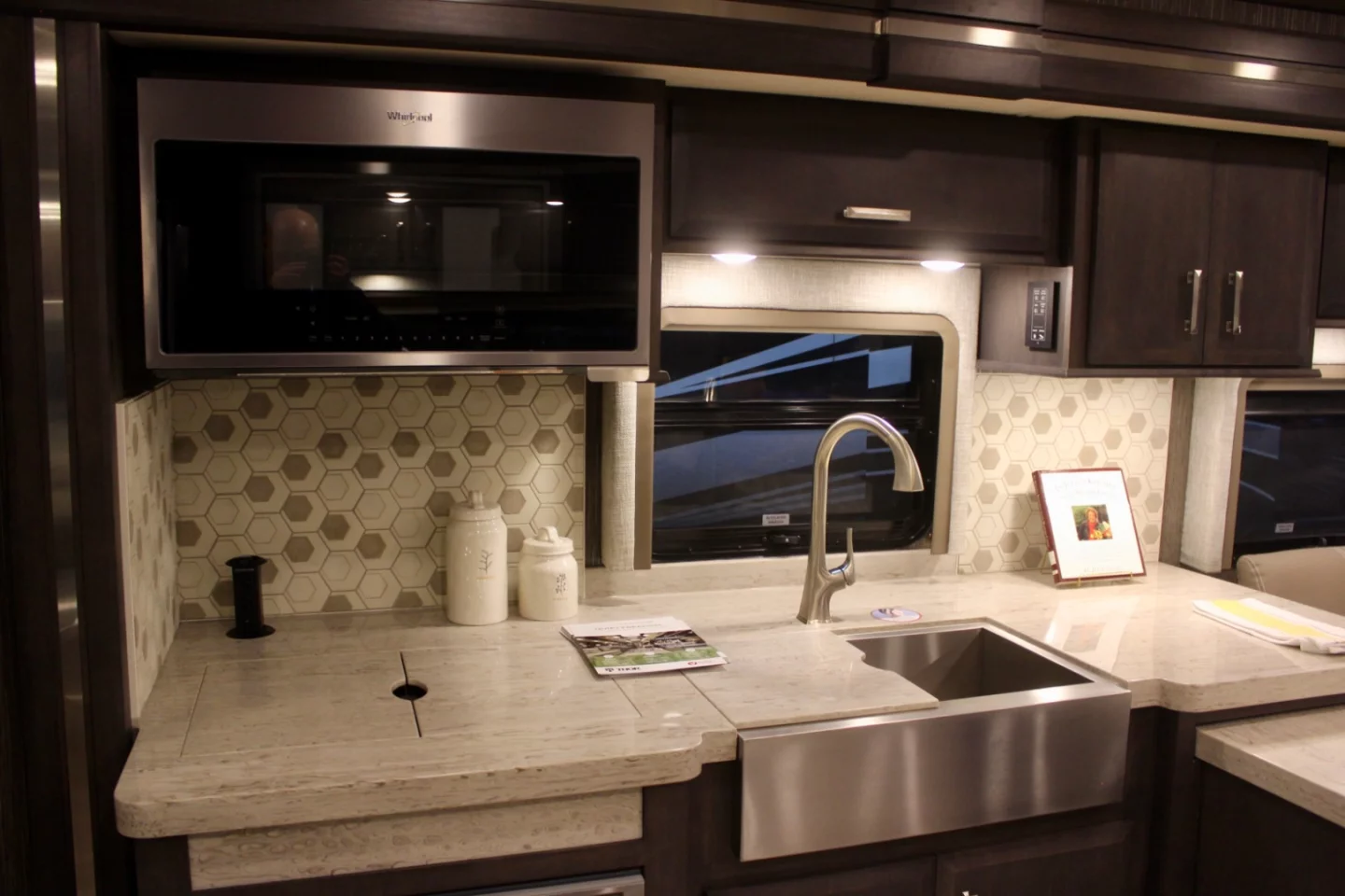 The concept kitchen area includes a totally updated look, along with handy equipment like a removable indoor/outdoor induction cooktop below the counter-matched lids