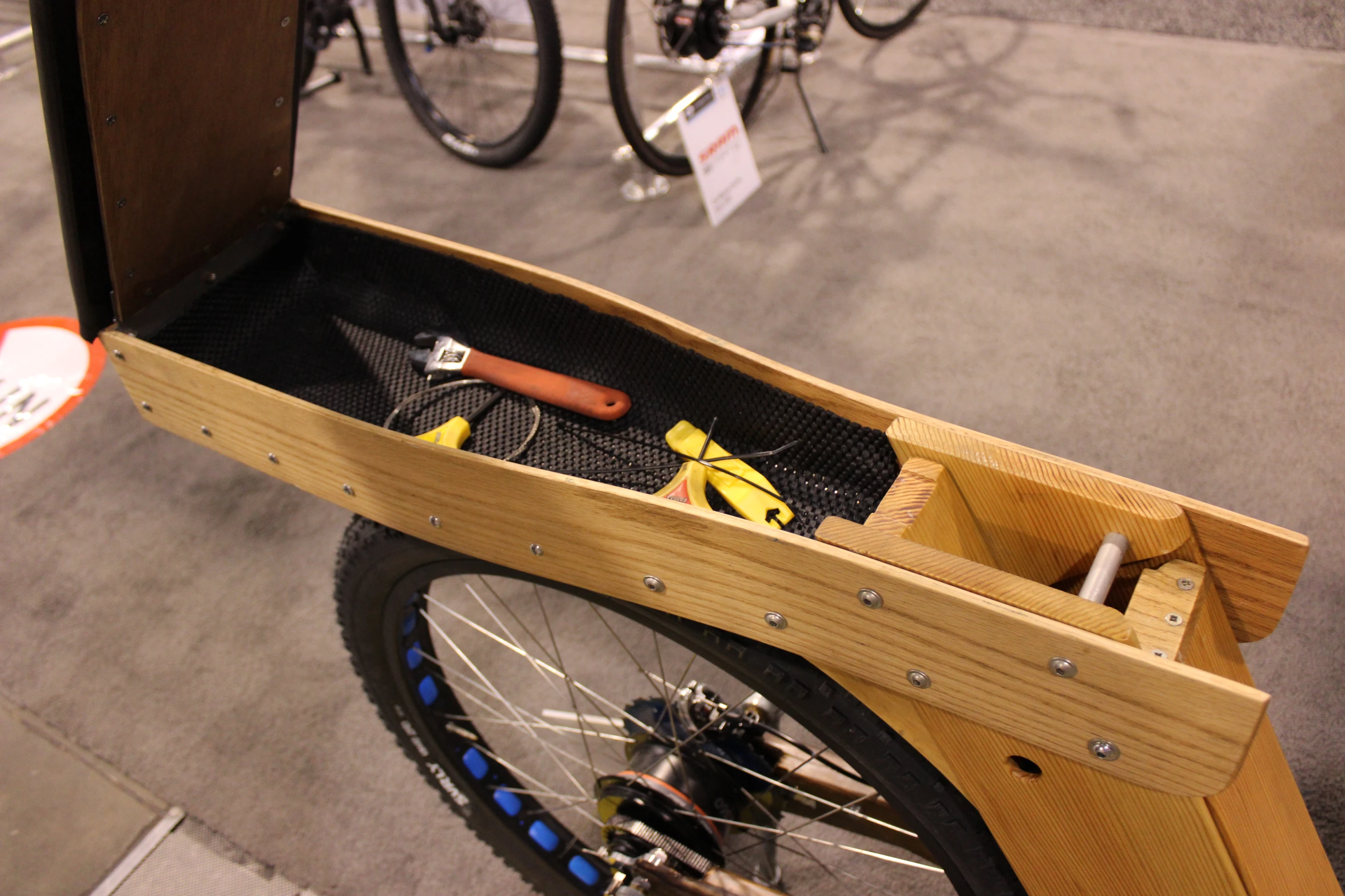 The seat opens up to reveal a tool box