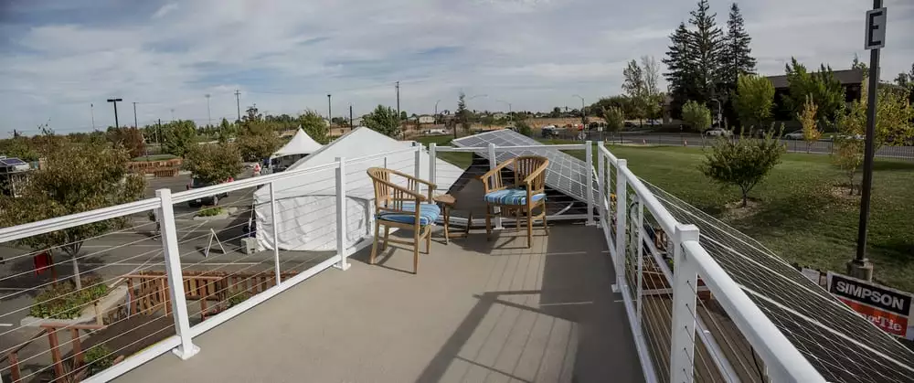An exterior staircase leads to the Revolve House's spacious roof deck