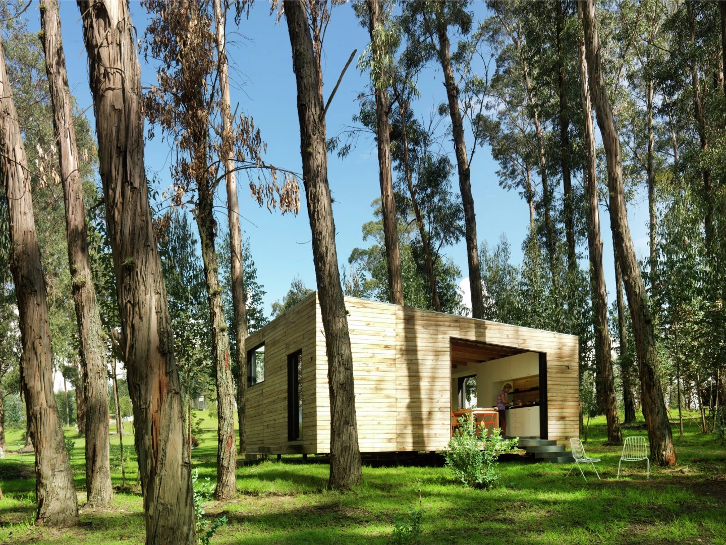 This main area of the house features a large floor to ceiling glass sliding wall, which allows natural light to flood in