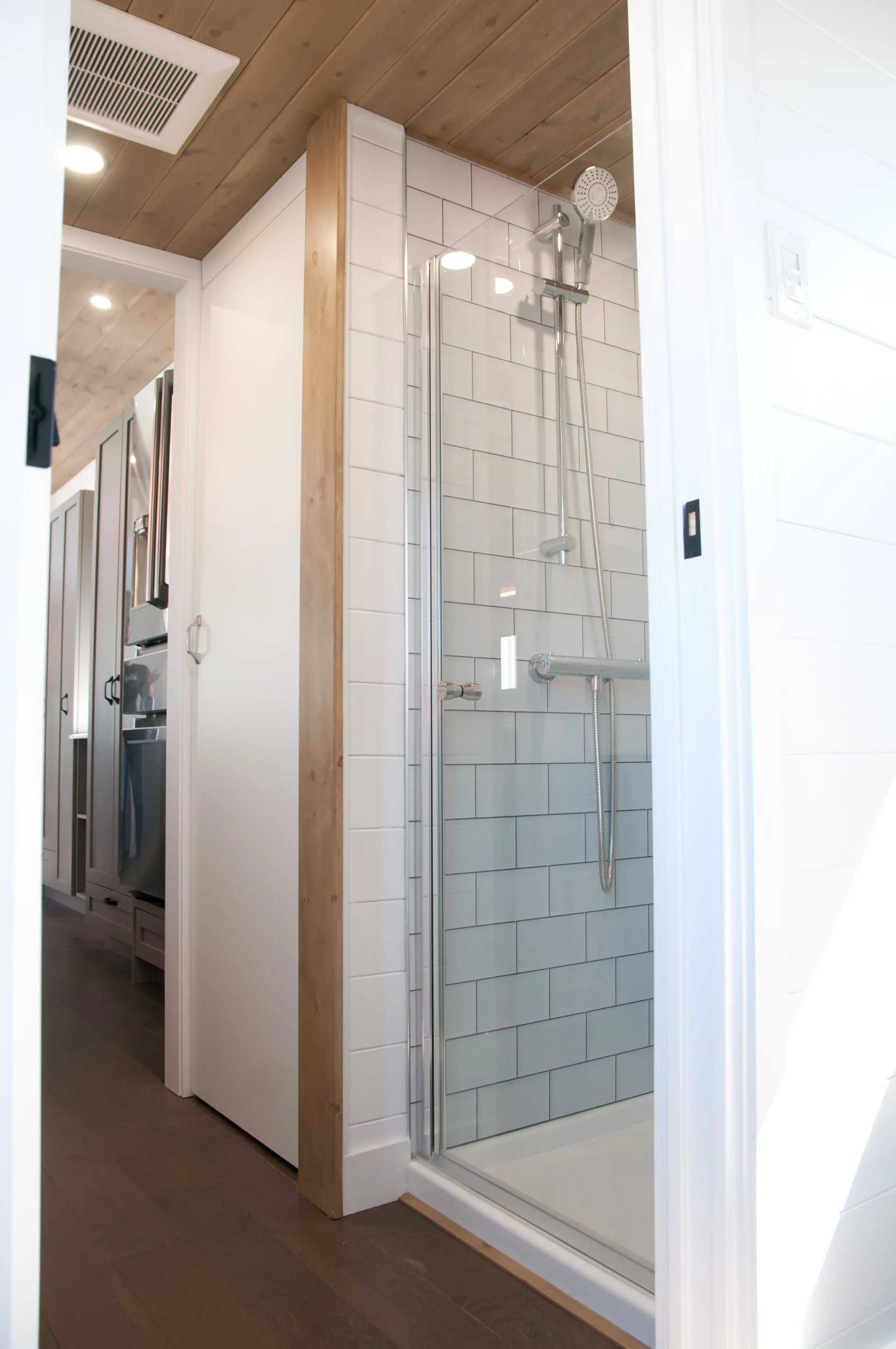 The Magnolia V6's bathroom includes a shower, sink, and flushing toilet