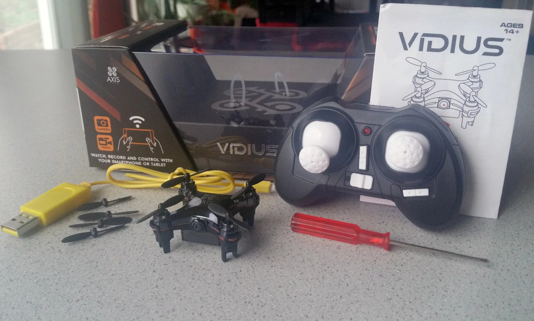 The Axis Drones Vidius comes complete with extra propellers, USB charge cable, transmitter (batteries sold separately), mini screwdriver, and instructions.