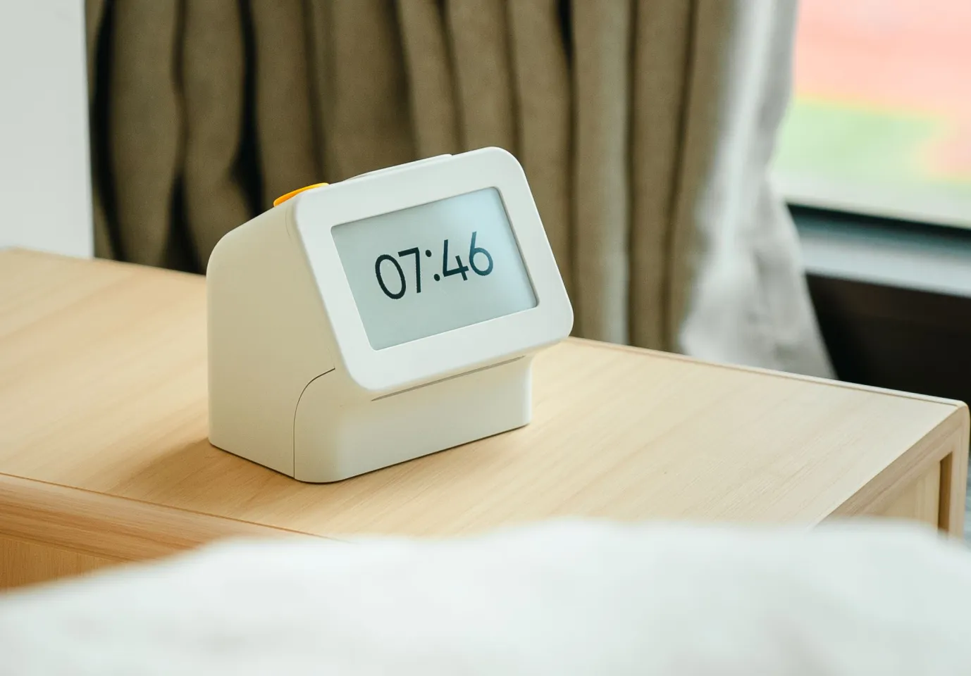The Habity bedside clock pairs a retro alarm-clock silhouette with a low-power e-paper display, designed to replace the phone on your nightstand