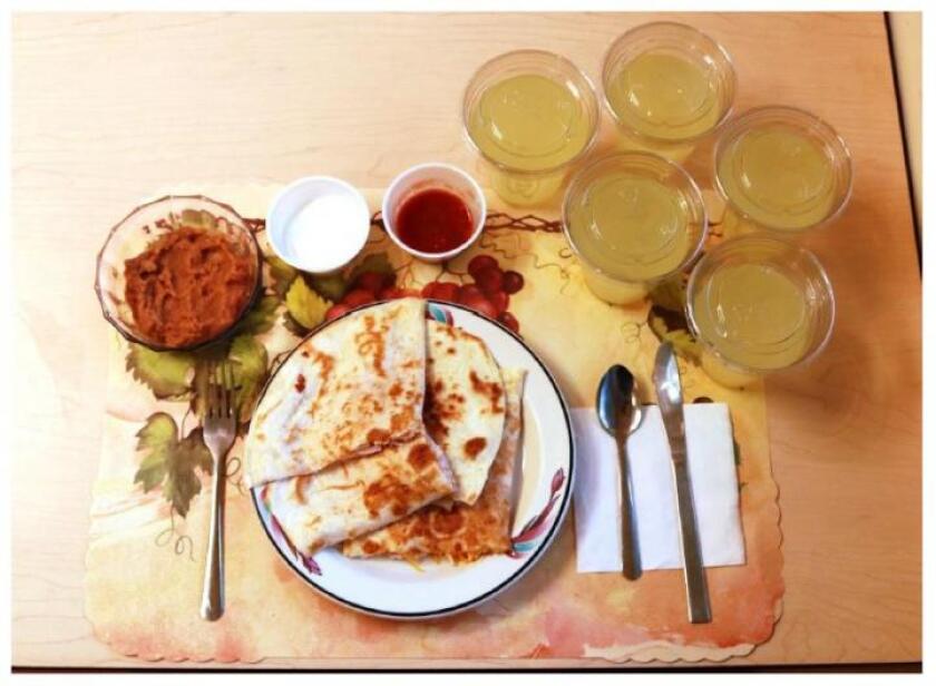 This image shows one of the study's processed lunches, consisting of quesadillas, refried beans, and diet lemonade