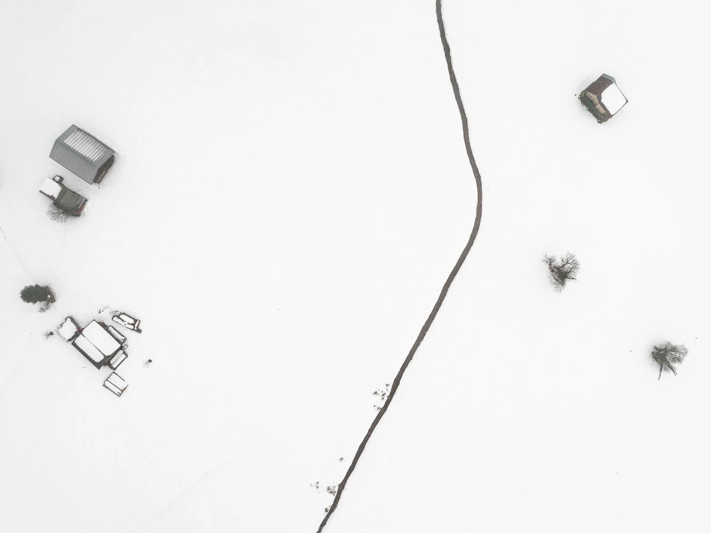 The Farmland Series: A look at farmland during winter in the Allgaeu Alps, a pre-alpine region in Germany. These open landscapes become dusted with white snow leaving only the human farming traces to stand out