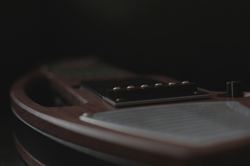The INSTRUMENT 1 features a sustainable hardwood and bamboo body of ergonomic design that can be held like a guitar, mandolin, violin, lap steel or upright bass, and a force sensitive virtual fretboard (with six virtual frets and strings)