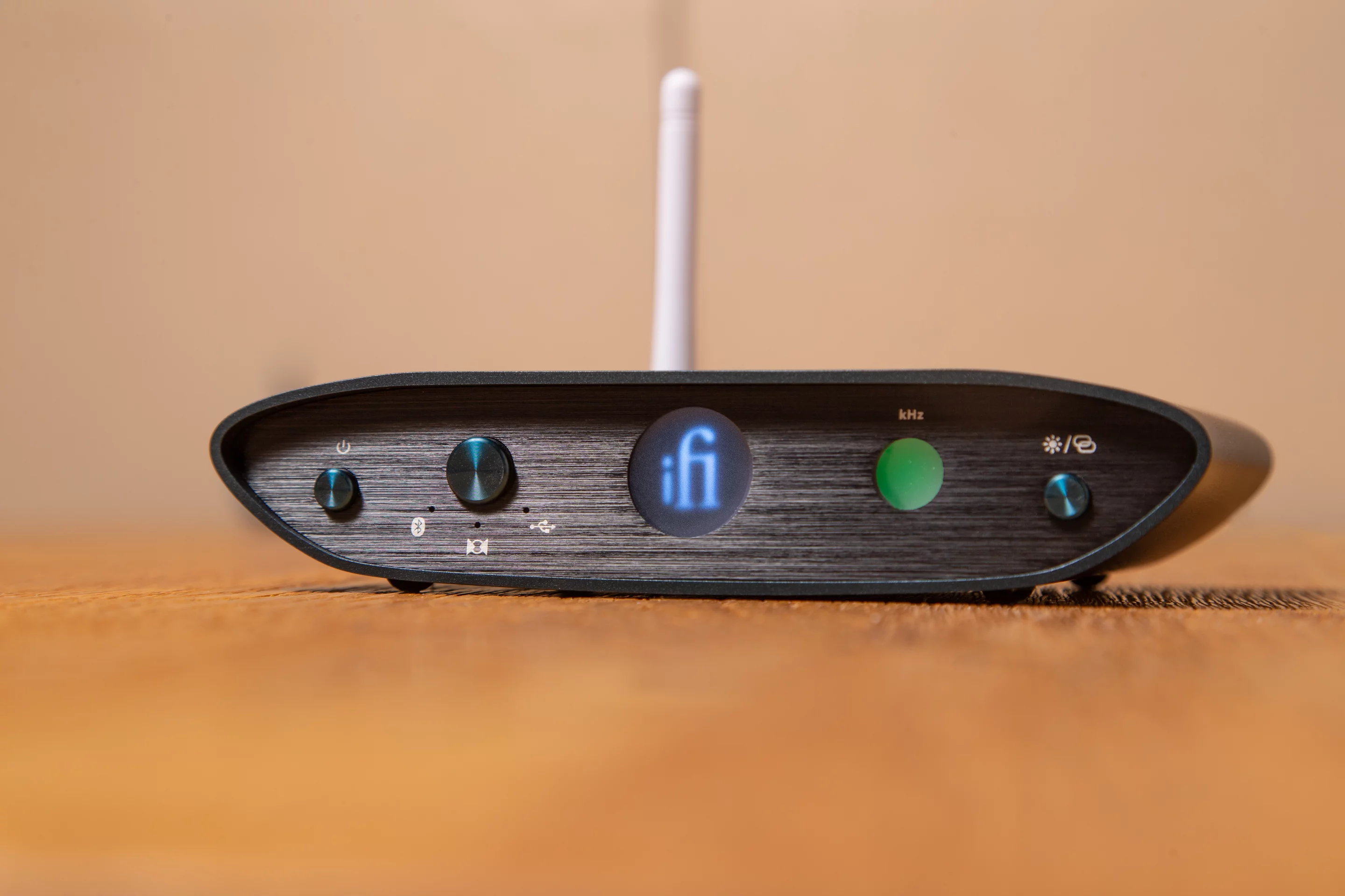 The front panel features an input source switch, a Bluetooth pairing button and LEDs that change color to show audio format type and sample rate