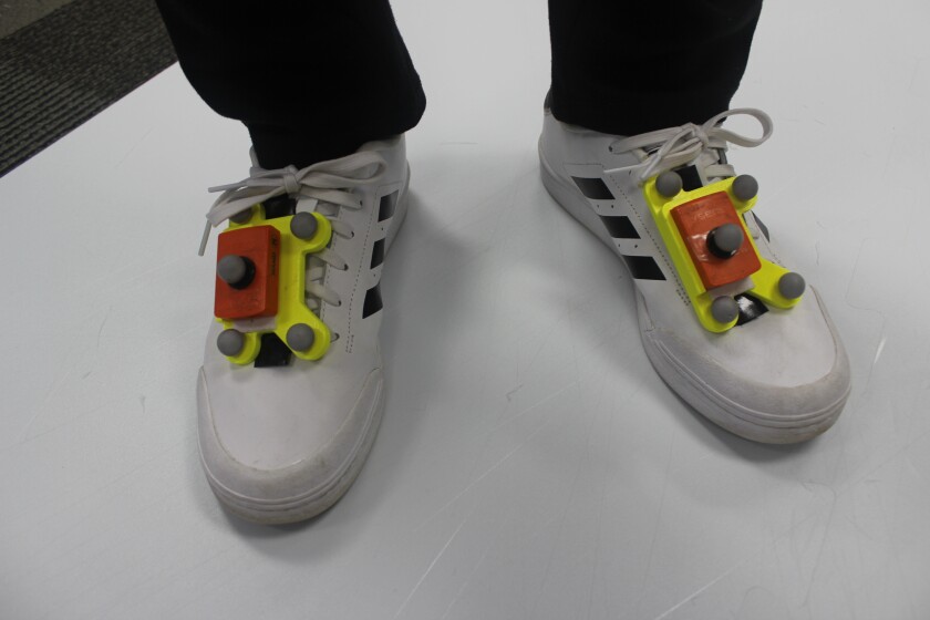 The system's combined retroreflective markers and IMUs