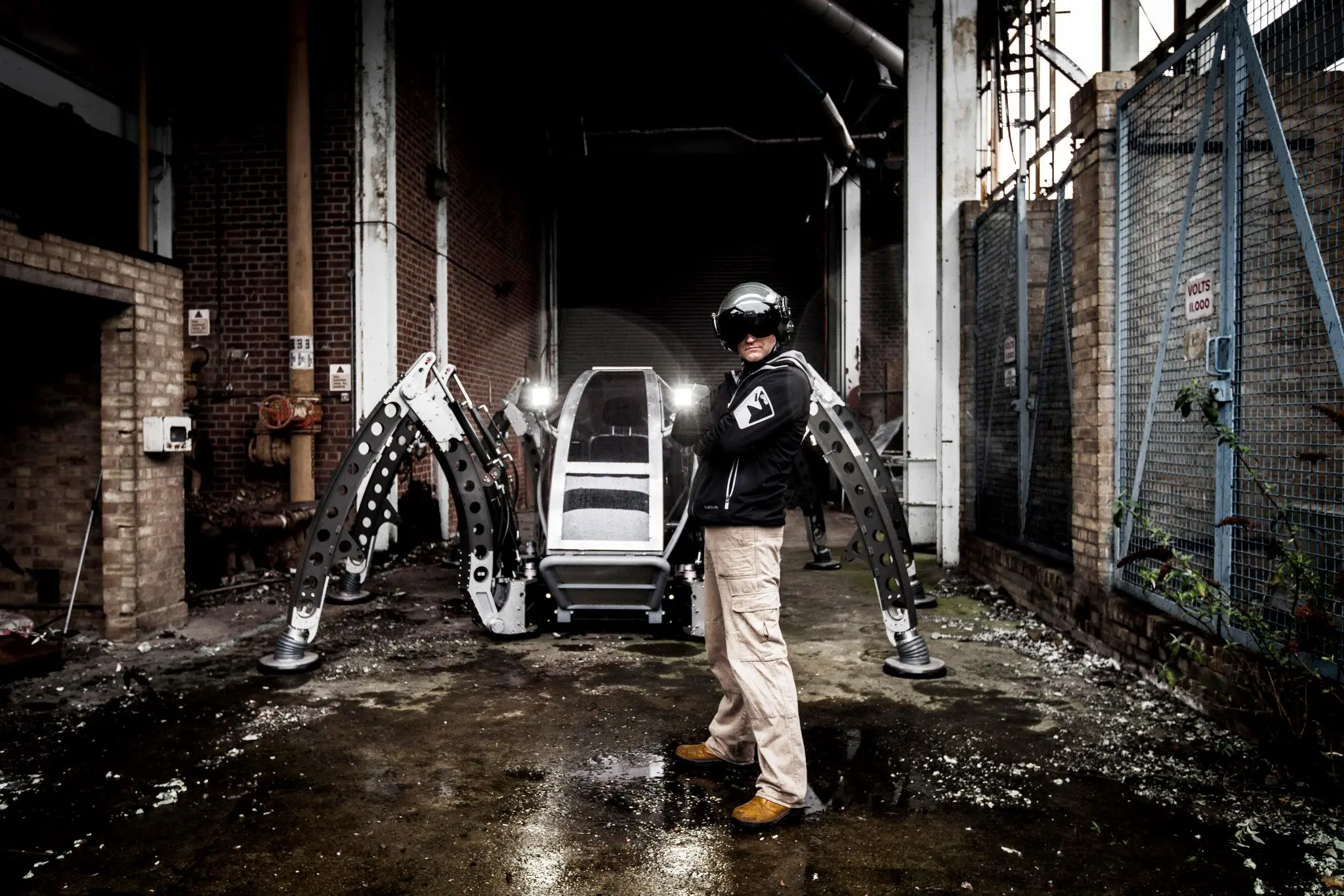 Chief designer Matt Denton stands proudly by his passion project, an enormous hexapod robot named Mantis